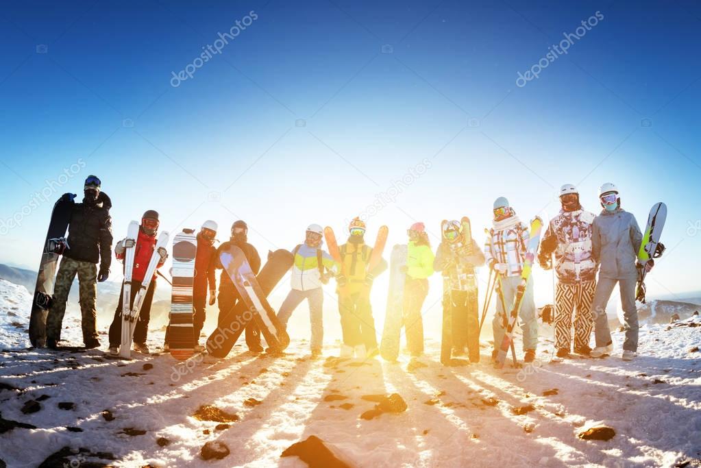 Group friends ski skiers snowboarders winter sports