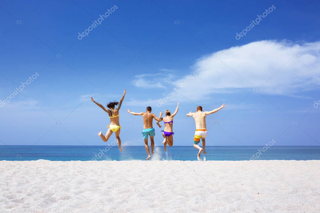 Happy friends on lonely beach