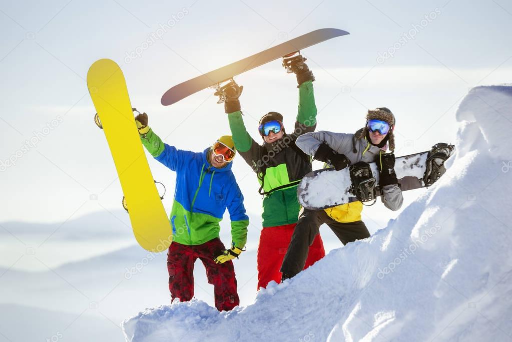 Group three happy snowboarders fun