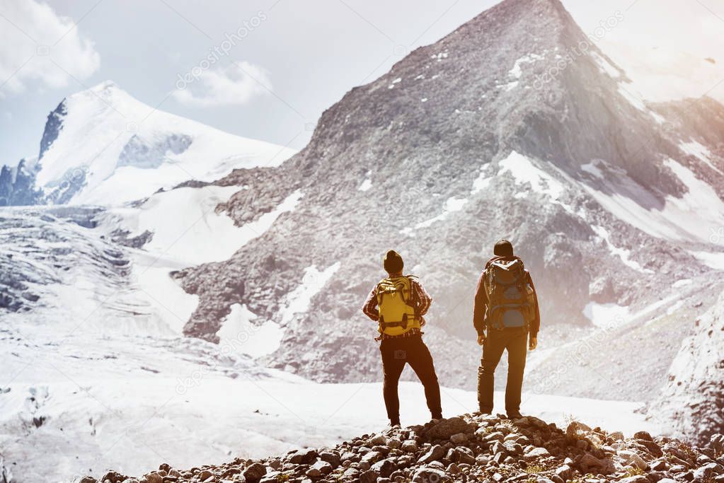 Two friends trekking mountains concept