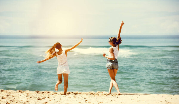 Two happy girls sea beach fun