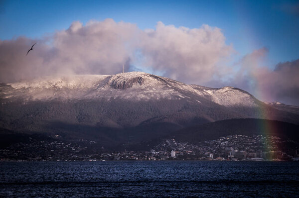 Hobart, Tasmania with Rainbow and snowy Mt. Wellington in Background