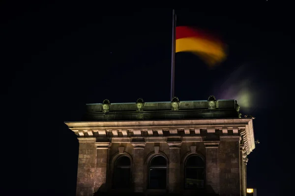 Německá vlajka v noci na budově říšského sněmu v Berlíně, Německo — Stock fotografie