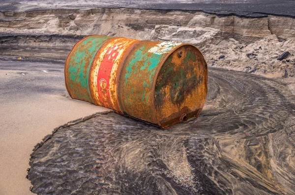 Старая ржавая баррель на пляже — стоковое фото