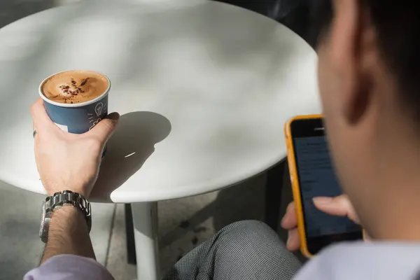 Бизнесмен, работающий со смартфоном в кафе . — стоковое фото