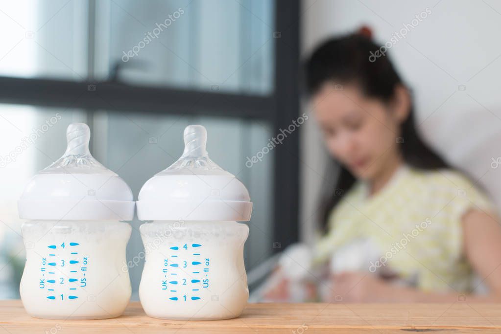 Baby bottle with breast milk for breastfeeding.