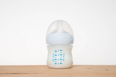 Beyaz arka planda bir şişe süt.