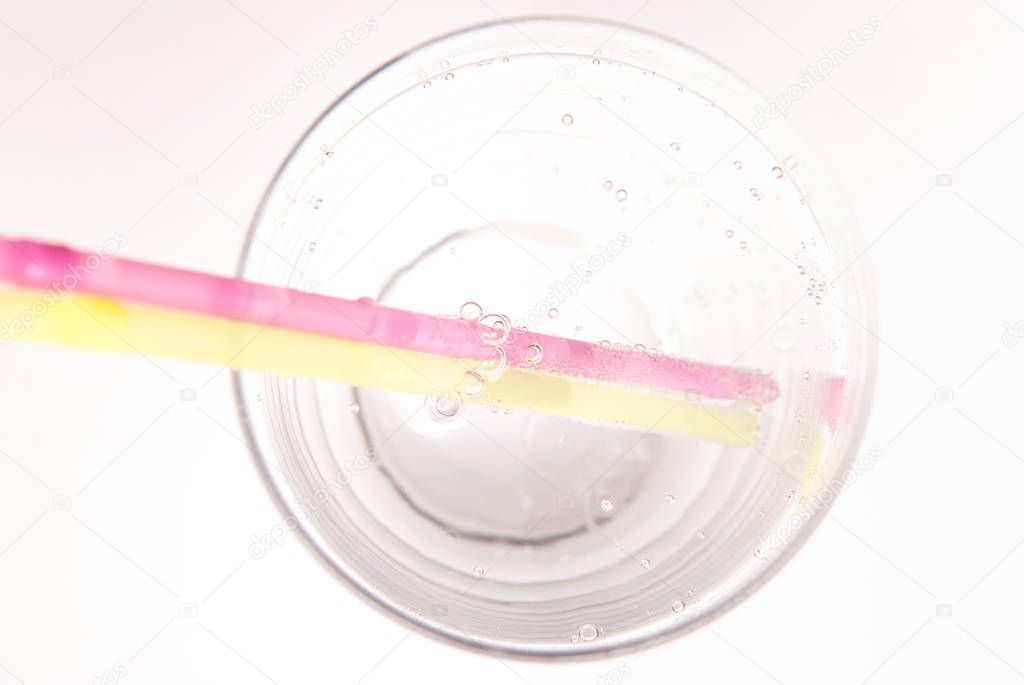 glass of fizzy water, refreshing cold drink with straws