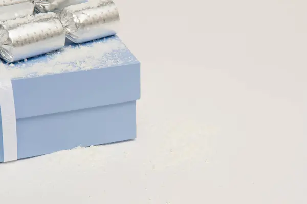 Blue Christmas present in a gift box with snow — Stock Photo, Image