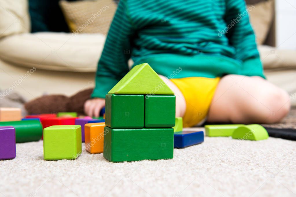 Child playing with building blocks learning new skills