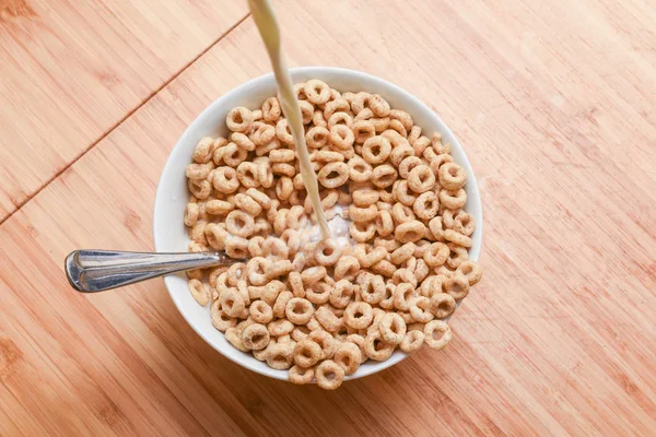 Breakfast cereal bowl with cold milk being poured at the morning — Stock Photo, Image