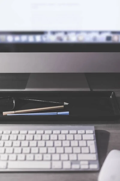 Verschwommener großer Computerbildschirm auf einem Schreibtisch im Home Office — Stockfoto