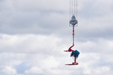 Crane hook hanging over an empty sky suspended in mid air