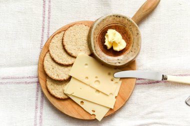 Cheese and biscuits snack of oat cakes with butter and emmental 