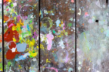 Wooden boards covered in paint creating random and abstract arti