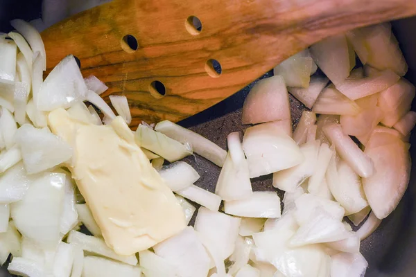 Готовить свеженарезанный лук с маслом на соуте в кастрюле — стоковое фото