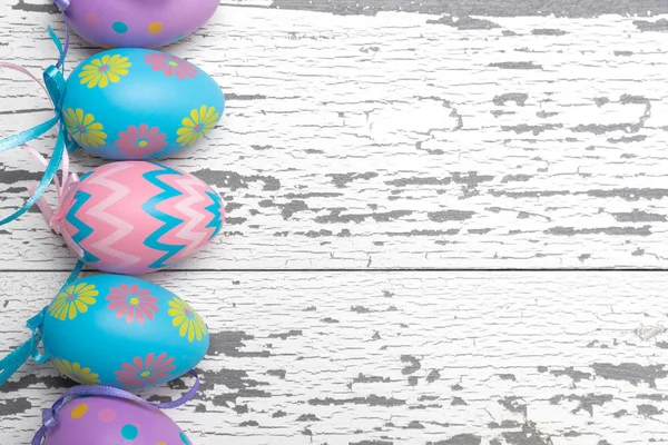 흰색 나무 바탕에 파스텔 색된 부활절 달걀의 그룹 — 스톡 사진