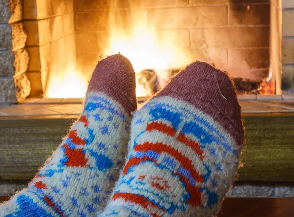 Man\'s Feet in socks; before fireplace  in cozy country house.