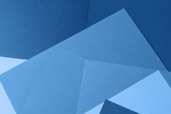 Minimal creative paper background toned in classic blue color.