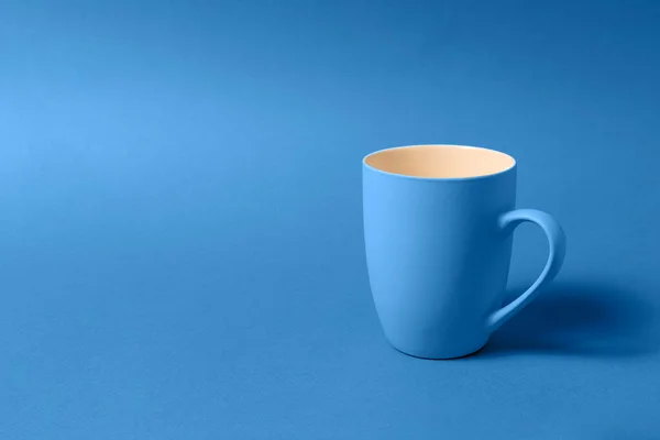 Blue color big mug over blue background.