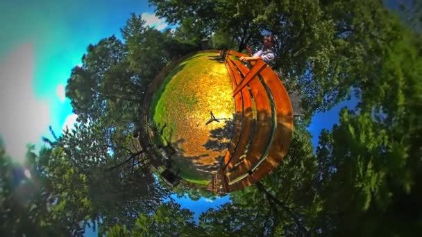 Little Tiny Planet 360 Degree Man Feeds the Goats Sunny Day Rural Opole Landscape Paddock Village Zoo Blue Sky Green Trees Tour to Opole Tourism in Poland — Stock Video