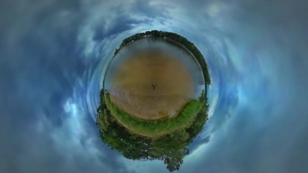 Little Tiny Planet 360 Degree Seaside Clouds Green Trees Lawn Grass Traveling Along Lake Bank Warm Autumn Day Cloudy Sky Park Forest Tour to Opole — стоковое видео