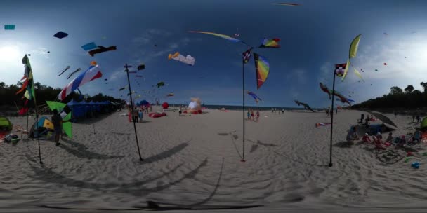 360 Vr Video People at Kites Festival Leba Toy Windmills Are Rotating at the Wind People Fly Colorful Kites of Different Shapes Kids Parents on Sandy Beach — стоковое видео