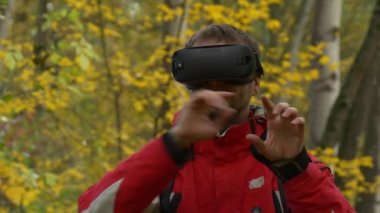 360vr gözlük tıklama hayali ekran açık havada Video izlerken erkekte 360 derece sanal oyun oyunlar sonbahar sarı bulutlu gün parkta bırakır ağaçta