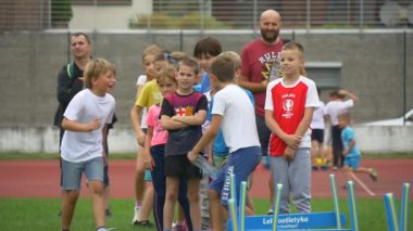 Opole, Poland - Sep 17 2016: Little Boys and Girls Jump Through Low Obstacles During Run. Each of Them Successfully Reaches a Finishing Line. Together Children Take Part in a Children's Sports