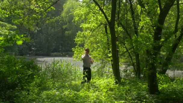 Descanso é Turista beco no Parque Falando por telefone Caminhando através de alta grama Árvores verdes Frescura em Sunny Summer Day Sunlight Weekends — Vídeo de Stock