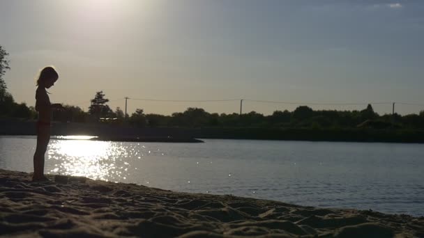 Girl Stands on a Bank of a Small Lake — Stock Video