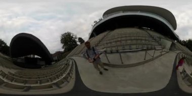 360Vr Video 360 Degrees, Man in Empty Theatre is Taking the Video Using a Selfie Stick. Millennium Amphitheatre in Opole, Exterior. Spherical Panorama. Little Girl is Standing at the Man, Dad and Daughter Together Among Empty Seats or Benches on