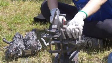 Adam bir kir ve bir Metal heykel pik demir Atölyesi açık havada göster Wroclaw City Polonya yüksek sıcaklıklar Festivali'nde turistler için işaretini kaldırın çalışır