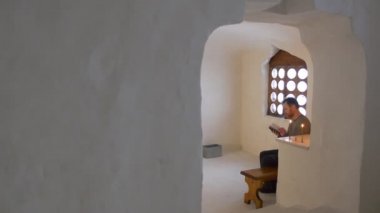 Mağara kilise kitap dini Kutsal metinleri İncil mum pencere okuma, dua ederken sallanan yalnız yanan tapan manastırda adamsın