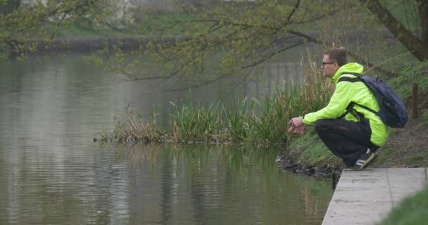 Man Photographs Reflexion in a Water — Stock Video