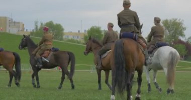 Opole, Poland - May 02 2016: Polish Flag Day in Opole. Soldiers, Riders Perform Formation While Riding on Horses, Kids in Safety Helmets Are Riding, Soldier Looking After Kids