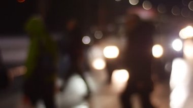 Misfocused görüntü insanlar geçerken yol araba durdu ve kaldırım yayalar tarafından yürüyüş yolu siluetleri vererek sokak Cityscape akşam tarafından yürümek