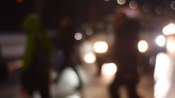 Misfocused Image of People Crossing Road Cars Stopped and Giving Them Way Silhouettes Walking by Sidewalk Pedestrians Walk by Evening Street Cityscape — Stock Video