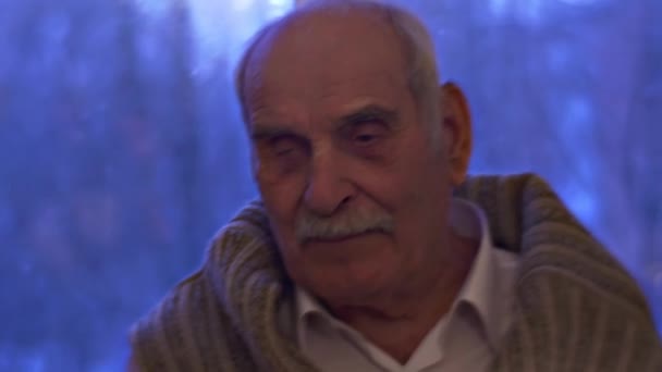 Senior Man at the Window Sick Grandfather is Smiling and Still Enjoying Life Sitting at the Window Grandad is Happy Telling Story — Stok Video