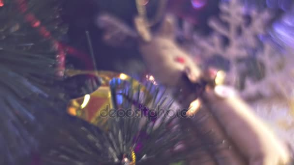 खिलौना हिरण और बॉल क्रिसमस ट्री सजावट पर महिला परिवार नए साल के पेड़ के पास पीपुल्स रूम में घर ब्लू लाइट्स में एक साथ अवकाश — स्टॉक वीडियो