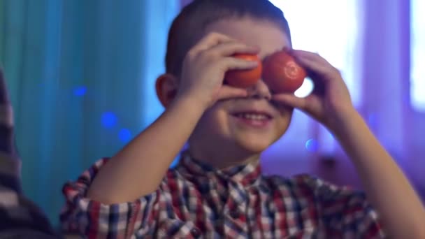 Little Boy Play Mandarines Showing Tongue Christmas Time — Stock Video