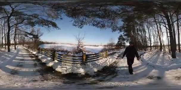 360vr відео сонячний день на краю міста взимку ландшафтного парку міста холодну погоду синій годину зйомки Синє небо голими гілки дерев чоловік іде топтали сніг — стокове відео