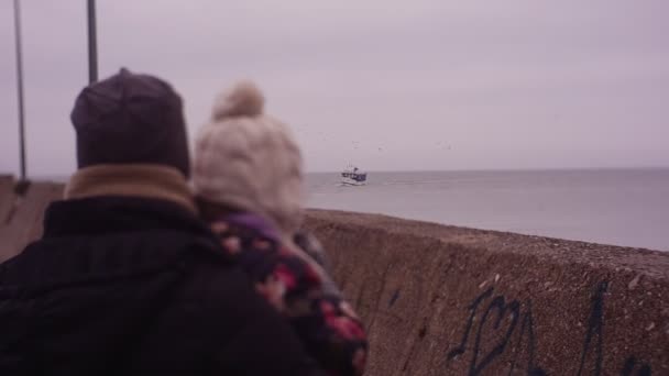 女孩和她的母亲望向一艘渔船 — 图库视频影像