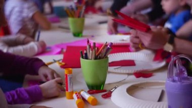 Opole, Poland - Feb 11 2017: Children Participate in a Master Class on Creation of Scenery From a Paper (Poland, Opole). They Sit at a Long Table. On a Table Various Tools and a Multi-Coloured Paper