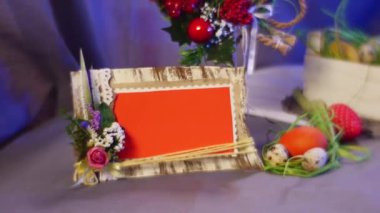 Opole, Poland - Feb 18 2017: Splendid Composition, From Easter Hen and Quail Eggs, Rosy Tulips, a Nice Easter Decor Yellow Ring and a Photo Frame, is Changed by a Hand, Taking a Photo Frame