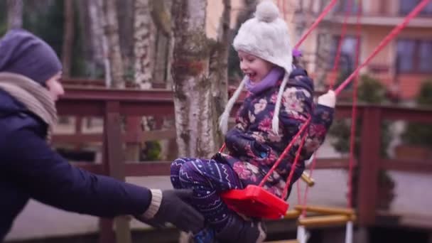 Girl Plays Children Playground She Sits Swing Young Birches Mum — стокове відео