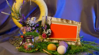 Opole, Poland - Jan 20 2017: Splendid Table Setting is Made of Easter Hen and Quail Eggs, a Festive Photo Frame, a Nice Bottle With a Candle, a Yellow Ring, a Set of Slide Cards, a Top Egg Cage