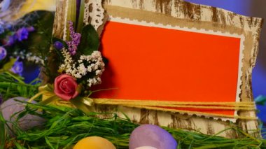 Opole, Poland - Jan 20 2017: Gorgeous Table Setting is Made of Easter Hen and Quail Eggs, a Festive Photo Frame, a Nice Bottle With a Candle, a Yellow Ring, a Set of Slide Cards, a Top Egg Cage