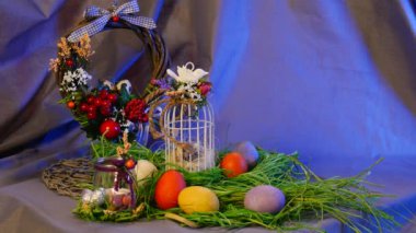 Opole, Poland - Jan 20 2017: Gorgeous Table Setting is Made of Easter Hen and Quail Eggs, a Festive Bottle With a Candle, a Brown Ring, a Nest From Greenary, a Top Egg Cage, Standing Near It