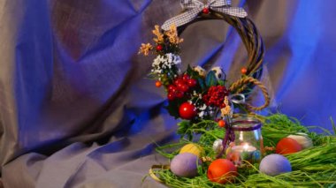 Opole, Poland - Jan 20 2017: Splendid Table Setting is Made of Easter Hen and Quail Eggs,a Nice Bottle With a Lit Candle, a Brown Ring, a Lot of Greenary, on a Round Table, With a Violet Background